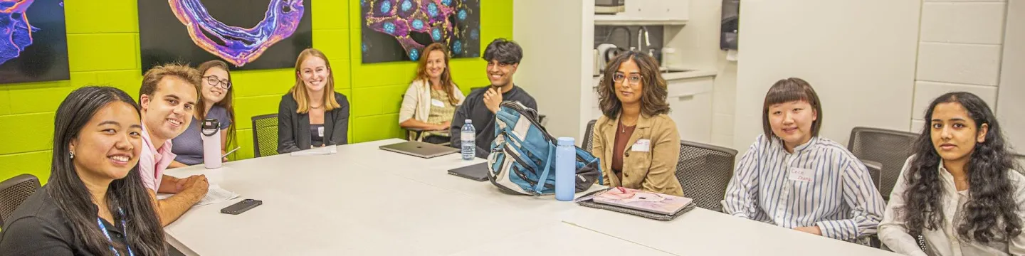 a group of students at a boardroom table