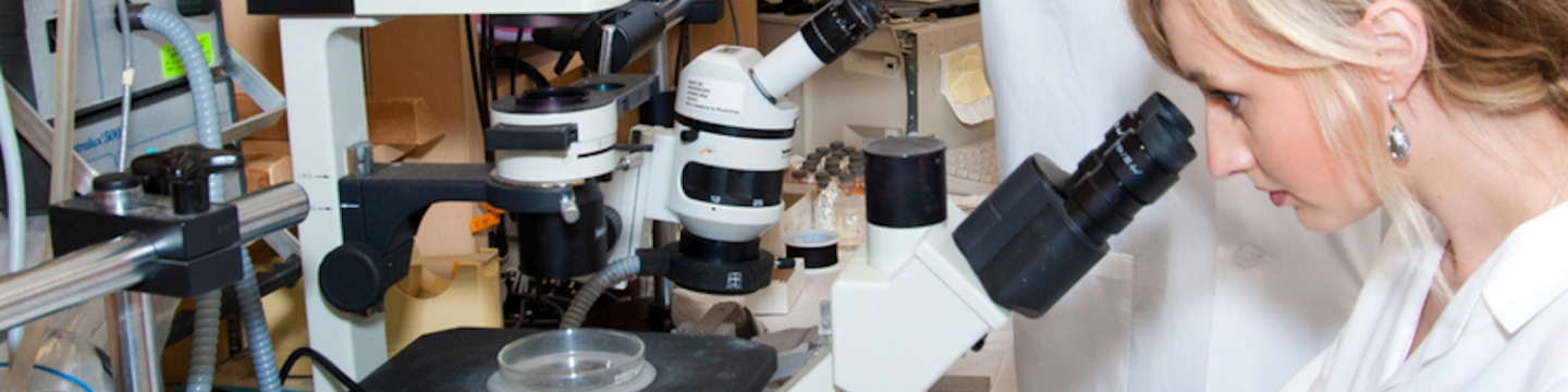 female biologist and microscope