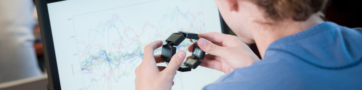 male student programming wearable technology