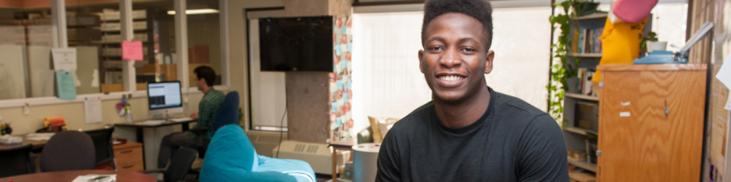 Dami sits in the writing centre