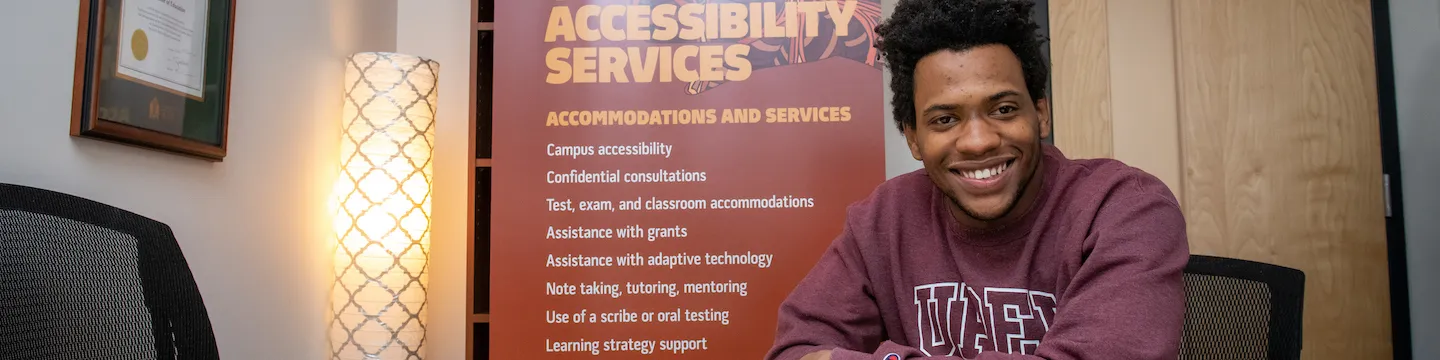 UPEI student Antwaun Rolle seated at boardroom table 