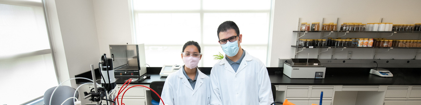 UPEI students Vidya Singh and Rabie Al Mialeh working in a laboratory