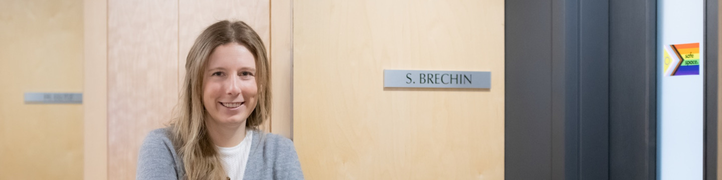 simone brechin leaning on her office doorway in UPEI's Dalton Hall