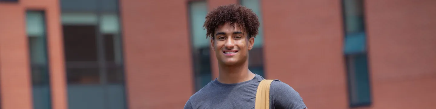 jeremy norman standing in front of upei's health sciences building