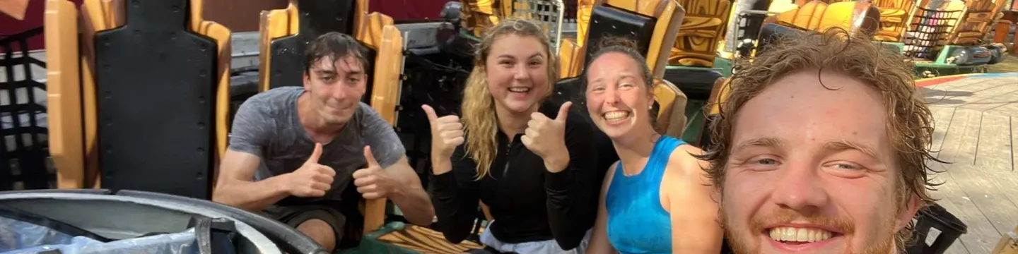 a group of four people on an amusement park ride