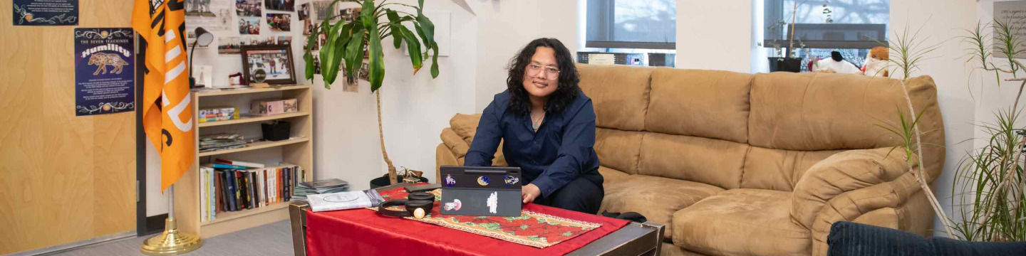 a UPEI student working on a laptop in the Mawi'omi Indigenous Student Centre