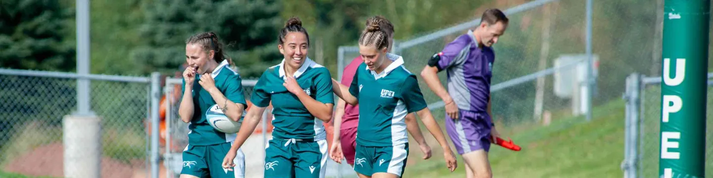 Three UPEI rugby athletes on the field 