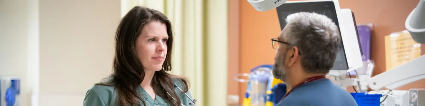 Dr. Aleisha Murnaghan speaking with another physician in the Queen Elizabeth Hospital emergency room