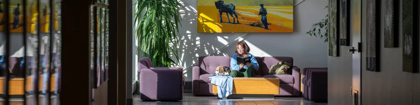 UPEI DVM student Tsukasa Iwamoto and a beagle at the Atlantic Veterinary College