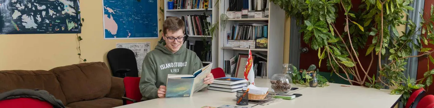 UPEI Master of Arts in Island Studies student Jack Weeks reading a book