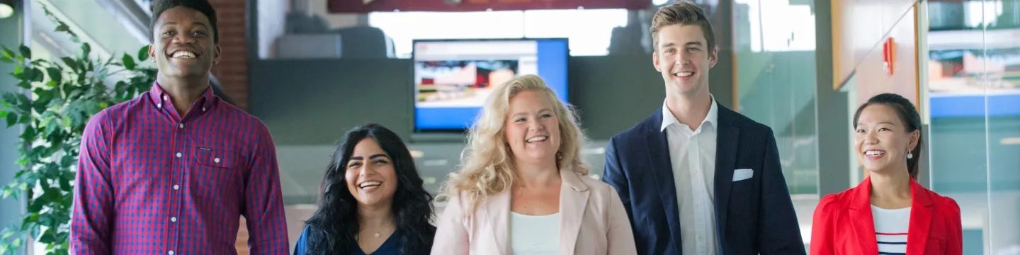 five UPEI Business students walking in a hallway