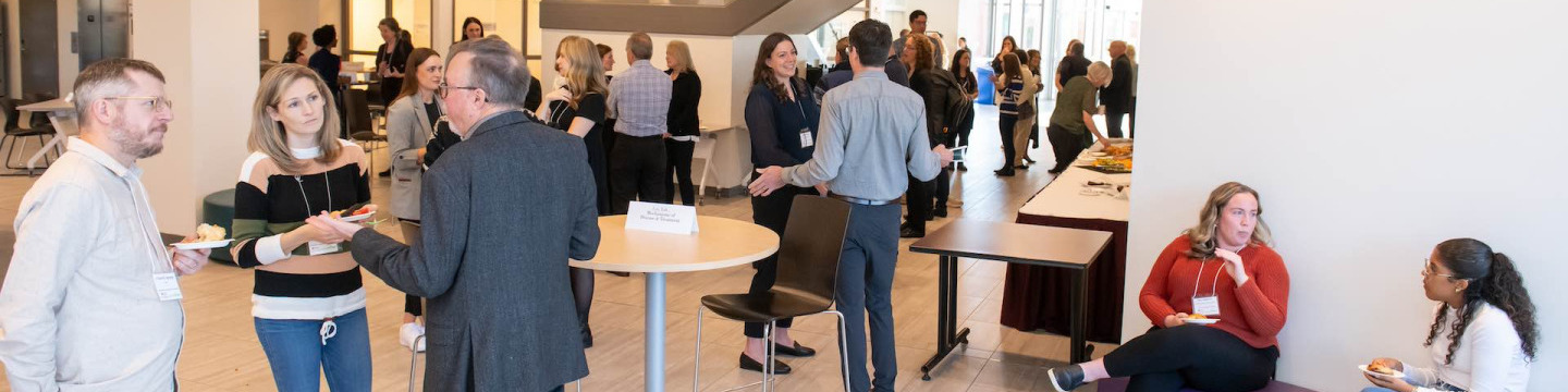 a large group of people at a research mixer