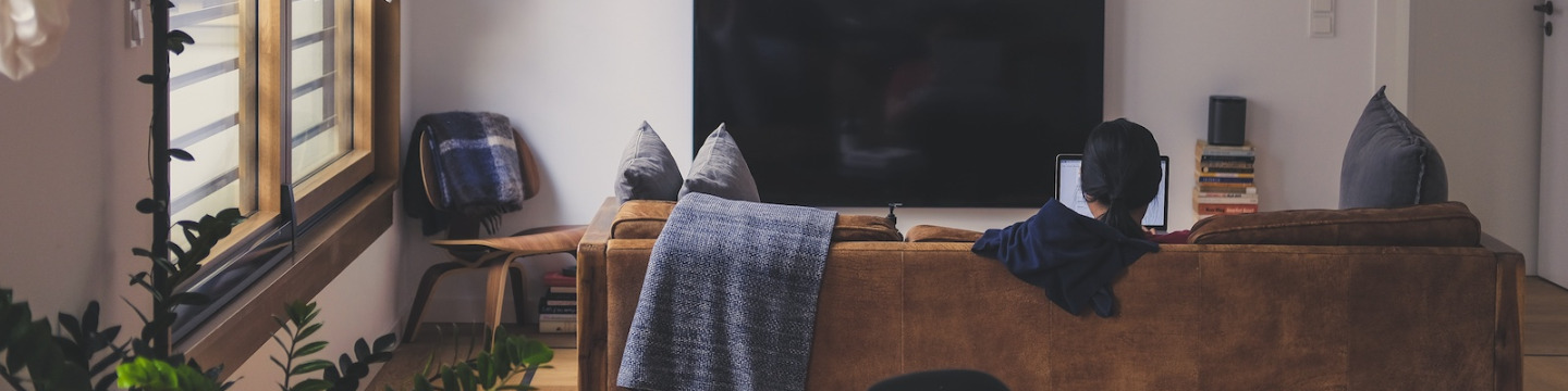a student at a laptop in an apartment
