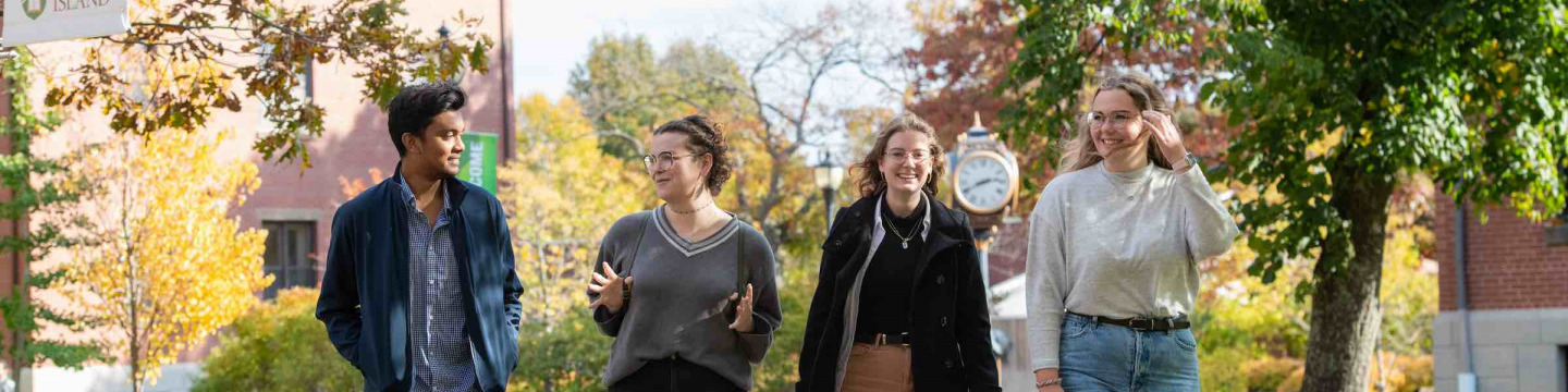 four students in the UPEI quad in fall