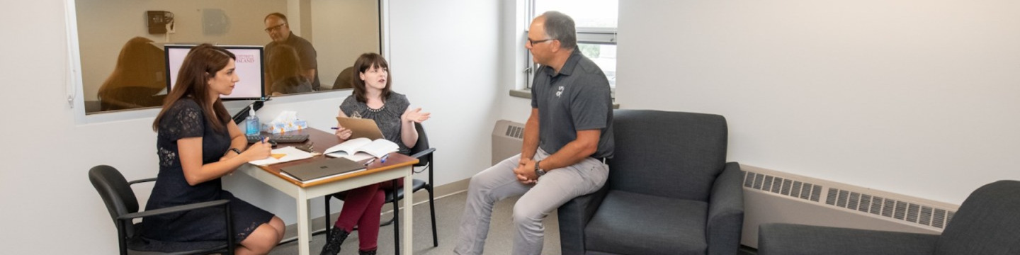 two students speaking with a clinical instructor