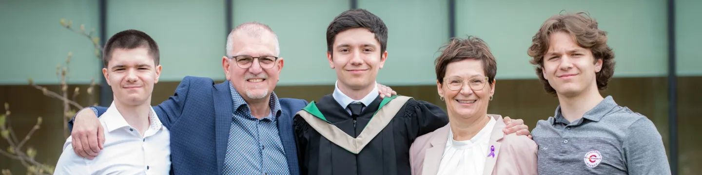 a family congratulate a graduate
