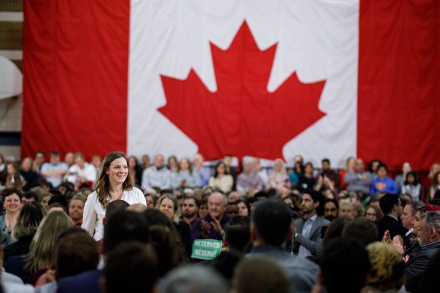Kate VanGerven at a ministerial announcement with a large crowd