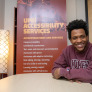 UPEI student Antwaun Rolle seated at boardroom table 