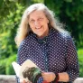 dr. jean mitchell photographed outside holding her book