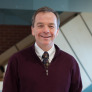 upei professor and researcher bill montelpare standing in health sciences building stairwell in background