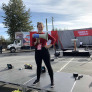 Kate VanGerven holding a megaphone on a flatbed truck
