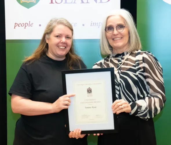 Tammy Ryan, Service Worker with UPEI Facilities Management, accepts the University Ambassador Award from Dr. Wendy Rodgers, UPEI President and Vice-Chancellor.