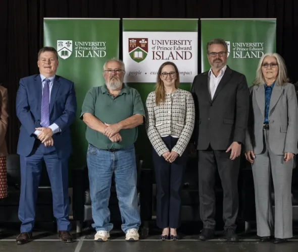 photo of group of people standing side by side on a stage