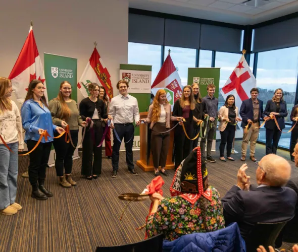 photo of a group of students holding pieces of ribbon