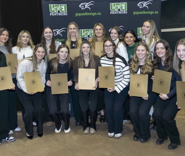 Members of the UPEI Women’s Hockey team gather for a photo after they receive their U SPORTS Academic All-Canadian certificates.