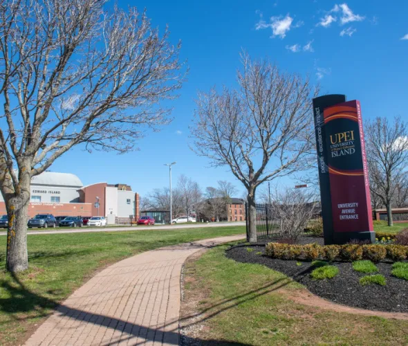 photo of sign in front of campus during spring