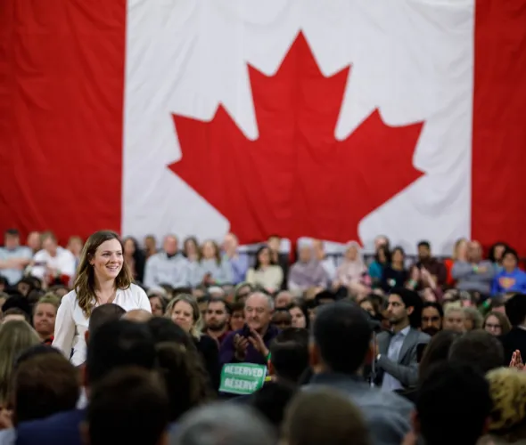 Kate VanGerven at a ministerial announcement with a large crowd