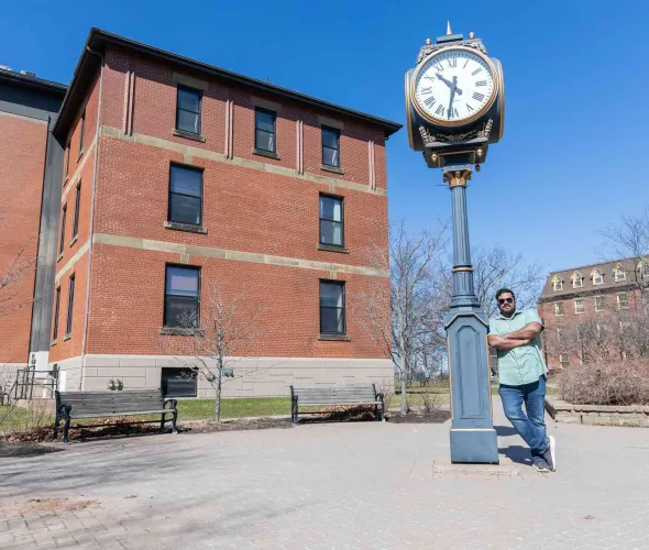 UPEI paramedicine student Bibin Peter by the UPEI clock