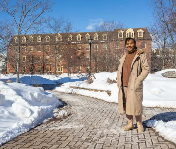 UPEI graduate Patience Adaobor standing in the quad in winter