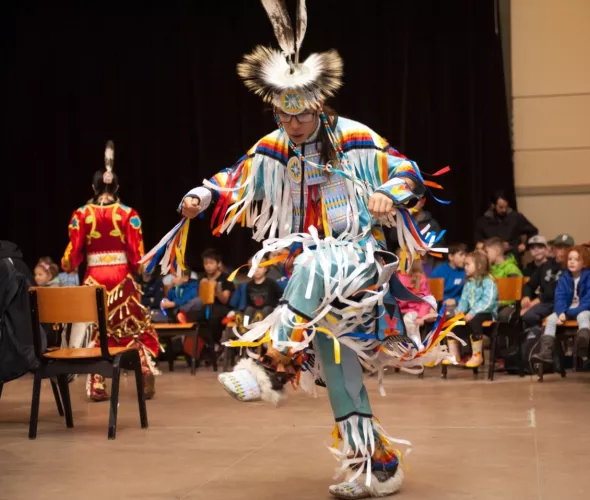 male dancer in colourful indigenous clothing