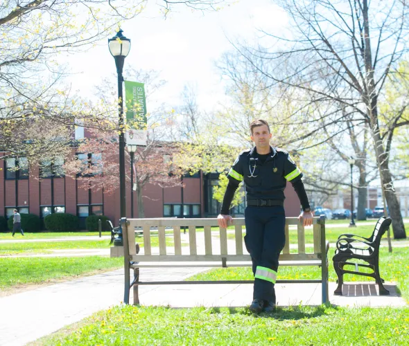 male paramedic standing in the UPEI quad